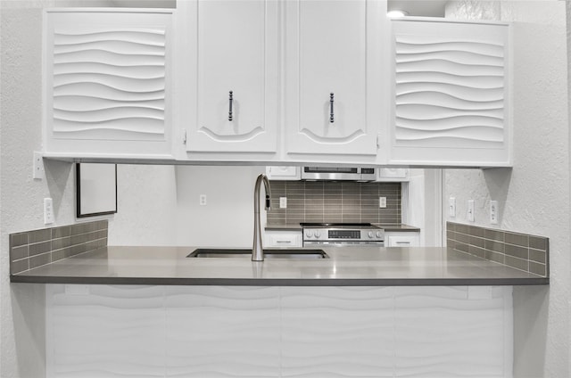 3022 Westforest Dr, Dallas, TX 75229 - kitchen featuring stainless steel electric stove, a sink, white cabinets, decorative backsplash, and dark countertops