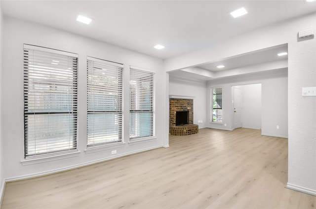 3022 Westforest Dr, Dallas, TX 75229 - unfurnished living room featuring light wood finished floors, baseboards, a brick fireplace, and a raised ceiling