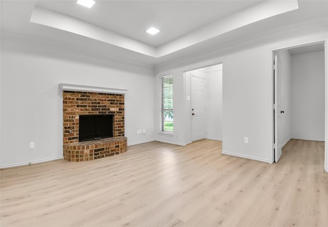 3022 Westforest Dr, Dallas, TX 75229 - unfurnished living room with a raised ceiling, light wood-style flooring, a fireplace, and baseboards