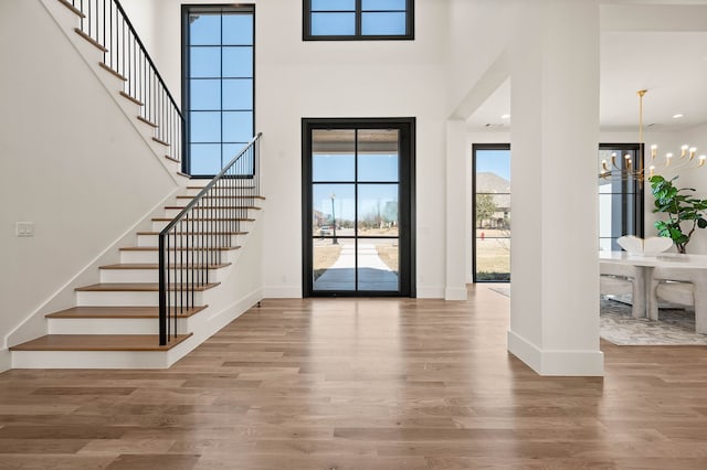 7115 Cast Iron Forest Trl, Colleyville, TX 76034 - entryway featuring stairs, wood finished floors, baseboards, and a towering ceiling