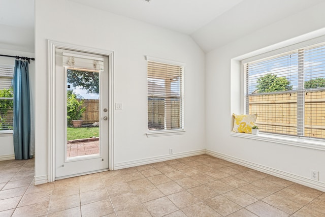 2912 Montalbo, Grand Prairie, TX 75054 - spare room featuring plenty of natural light, lofted ceiling, baseboards, and light tile patterned floors