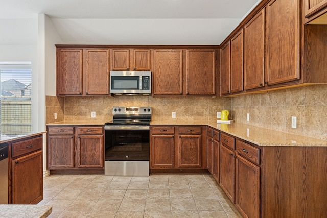 2912 Montalbo, Grand Prairie, TX 75054 - kitchen with appliances with stainless steel finishes, tasteful backsplash, light stone countertops, and brown cabinetry