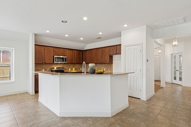 2912 Montalbo, Grand Prairie, TX 75054 - kitchen featuring stainless steel appliances, backsplash, light tile patterned floors, recessed lighting, and an island with sink
