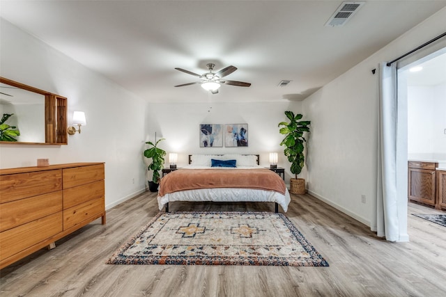 bedroom featuring light wood finished floors, baseboards, and ceiling fan