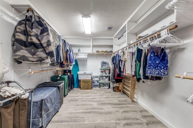 spacious closet featuring wood finished floors
