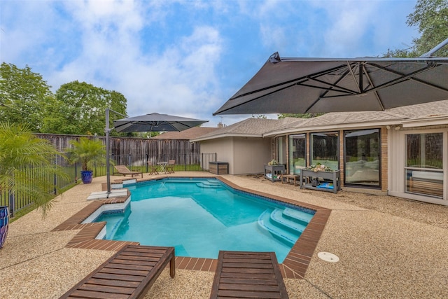 view of swimming pool with a fenced backyard and a patio area