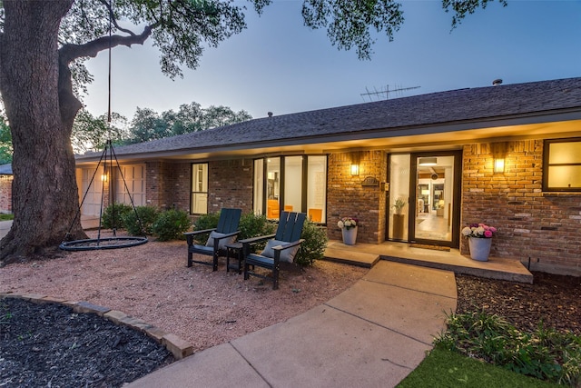 rear view of property featuring brick siding