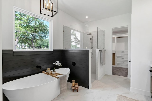 9001 Emma Ct, Granbury, TX 76049 - bathroom with a walk in shower, plenty of natural light, marble look tiles, and recessed lighting