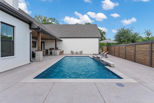9001 Emma Ct, Granbury, TX 76049 - view of pool with a patio, an outdoor kitchen, a fenced backyard, and grilling area