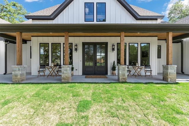 9001 Emma Ct, Granbury, TX 76049 - back of property with a shingled roof, board and batten siding, a lawn, and french doors