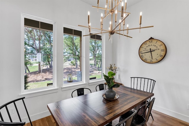 9001 Emma Ct, Granbury, TX 76049 - dining space featuring plenty of natural light, baseboards, wood finished floors, and a chandelier