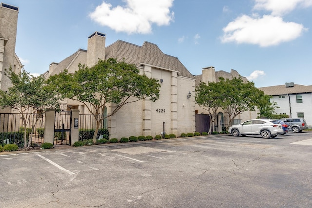 4229 Cole Ave Unit 115, Dallas, TX 75205 - view of property featuring uncovered parking and fence