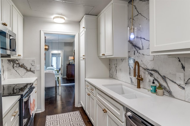 4229 Cole Ave Unit 115, Dallas, TX 75205 - kitchen featuring stainless steel appliances, a sink, decorative backsplash, white cabinets, and dark wood-style flooring