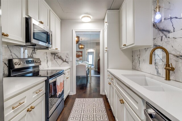 4229 Cole Ave Unit 115, Dallas, TX 75205 - kitchen featuring appliances with stainless steel finishes, a sink, dark wood-style floors, and light countertops