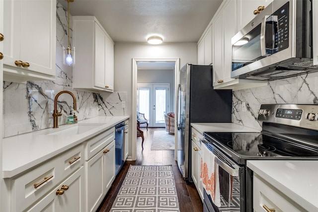 4229 Cole Ave Unit 115, Dallas, TX 75205 - kitchen featuring stainless steel appliances, a sink, white cabinets, backsplash, and light countertops