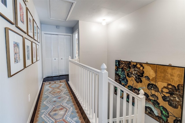 4229 Cole Ave Unit 115, Dallas, TX 75205 - hall featuring an upstairs landing, baseboards, and attic access