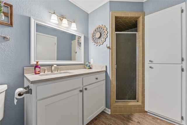 4325 Shady Glen Dr, Waco, TX 76708 - bathroom featuring a textured wall, a stall shower, wood finished floors, vanity, and toilet