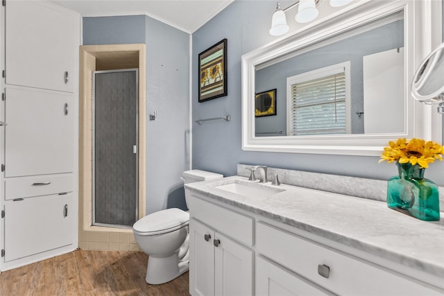 4325 Shady Glen Dr, Waco, TX 76708 - bathroom featuring wood finished floors, crown molding, a stall shower, vanity, and toilet