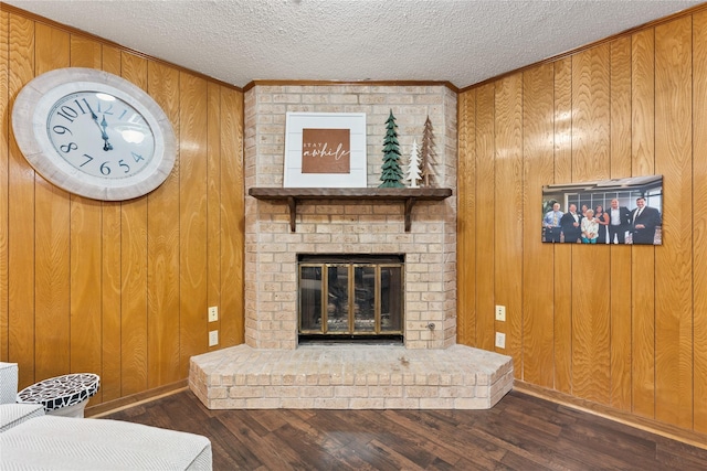 4325 Shady Glen Dr, Waco, TX 76708 - living room featuring wood walls, wood finished floors, a fireplace, ornamental molding, and baseboards