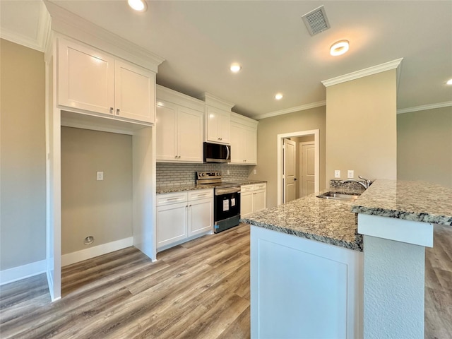2004 Clay St, Mabank, TX 75147 - kitchen featuring stainless steel appliances, a sink, ornamental molding, white cabinetry, and light stone countertops