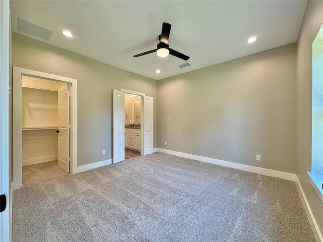 2004 Clay St, Mabank, TX 75147 - unfurnished bedroom featuring carpet flooring, a walk in closet, baseboards, connected bathroom, and recessed lighting
