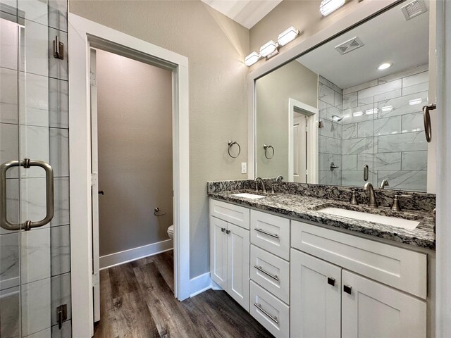 2004 Clay St, Mabank, TX 75147 - full bath featuring a stall shower, toilet, wood finished floors, double vanity, and baseboards