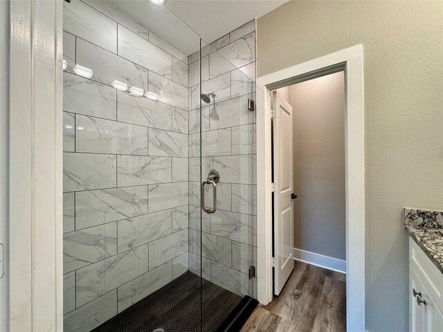 2004 Clay St, Mabank, TX 75147 - bathroom with a shower stall, wood finished floors, and vanity
