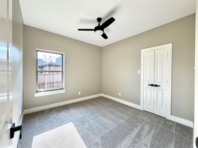 2004 Clay St, Mabank, TX 75147 - unfurnished bedroom with dark colored carpet, baseboards, a ceiling fan, and a closet