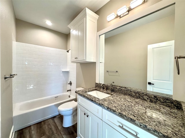 2004 Clay St, Mabank, TX 75147 - bathroom with wood finished floors, toilet, tub / shower combination, vanity, and recessed lighting