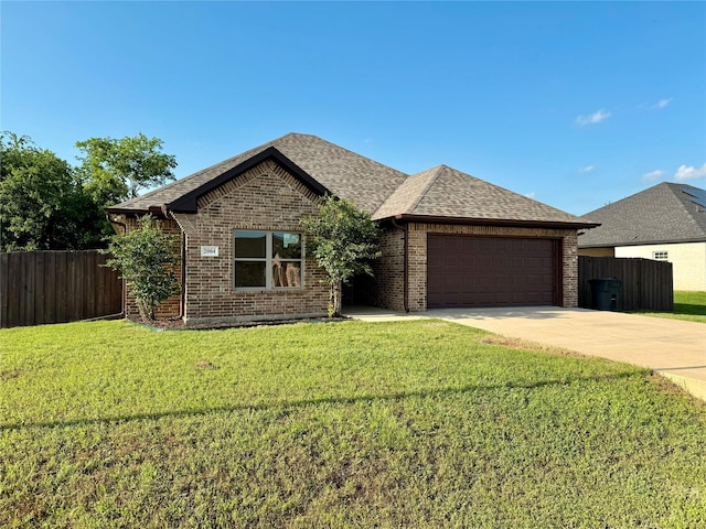 2004 Clay St, Mabank, TX 75147 - view of front facade featuring an attached garage, concrete driveway, brick siding, and a shingled roof