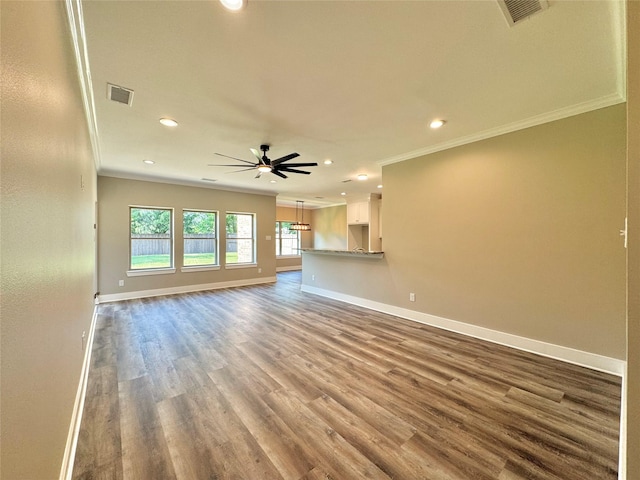 2004 Clay St, Mabank, TX 75147 - unfurnished living room featuring crown molding, recessed lighting, baseboards, ceiling fan, and wood finished floors
