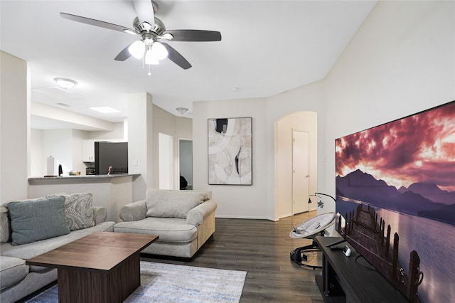 living area featuring wood finished floors, a ceiling fan, and baseboards