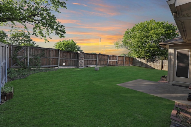 yard at dusk with a patio area