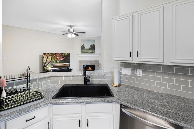 kitchen featuring a sink, a ceiling fan, backsplash, and dishwasher