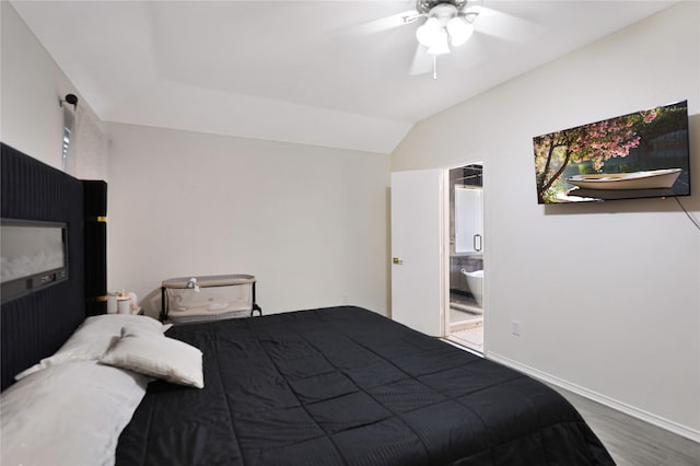 bedroom with wood finished floors, ceiling fan, lofted ceiling, connected bathroom, and baseboards