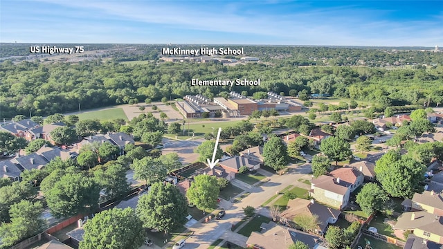 aerial view of property and surrounding area with nearby suburban area