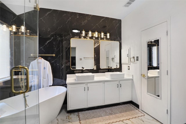 full bathroom with marble tiled flooring, double vanity, a freestanding bath, and a shower with door