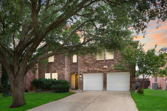 6005 Mariposa Dr, Mckinney, TX 75070 - traditional-style house with concrete driveway, central AC, a garage, a front yard, and brick siding