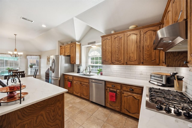 1608 Fallingwater Trl, Fort Worth, TX 76052 - kitchen featuring wall chimney range hood, appliances with stainless steel finishes, a sink, lofted ceiling, and tasteful backsplash