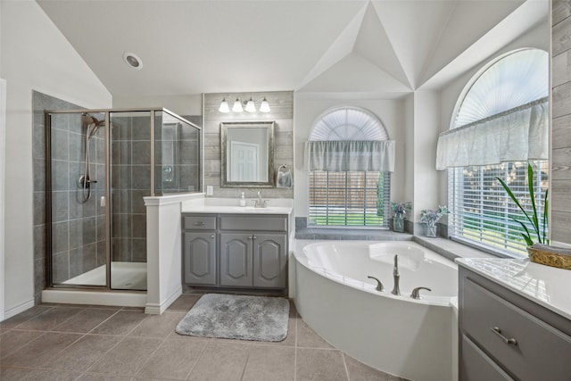 1608 Fallingwater Trl, Fort Worth, TX 76052 - bathroom featuring lofted ceiling, vanity, a stall shower, a bath, and tile patterned flooring