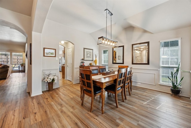 1608 Fallingwater Trl, Fort Worth, TX 76052 - dining room with arched walkways, light wood-style flooring, and lofted ceiling