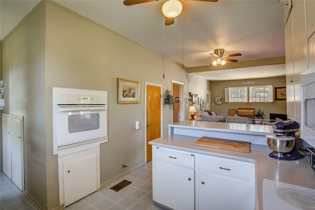 1005 Church St, Sulphur Springs, TX 75482 - kitchen with white appliances, ceiling fan, light countertops, and white cabinetry