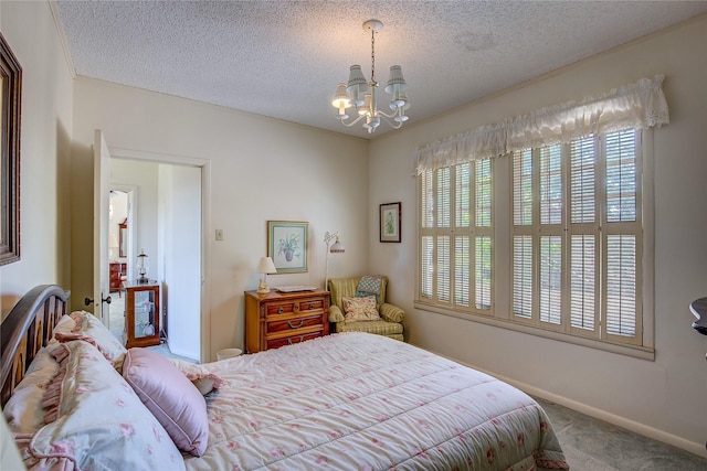 1005 Church St, Sulphur Springs, TX 75482 - bedroom with carpet flooring, a chandelier, a textured ceiling, and baseboards