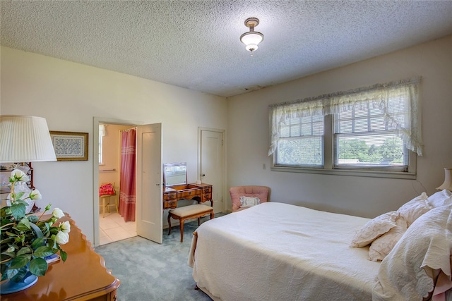 1005 Church St, Sulphur Springs, TX 75482 - bedroom featuring carpet flooring, a textured ceiling, and ensuite bathroom