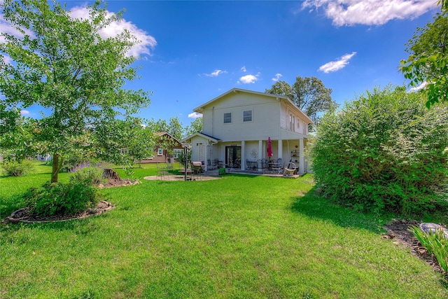 1005 Church St, Sulphur Springs, TX 75482 - back of house featuring a patio area and a lawn