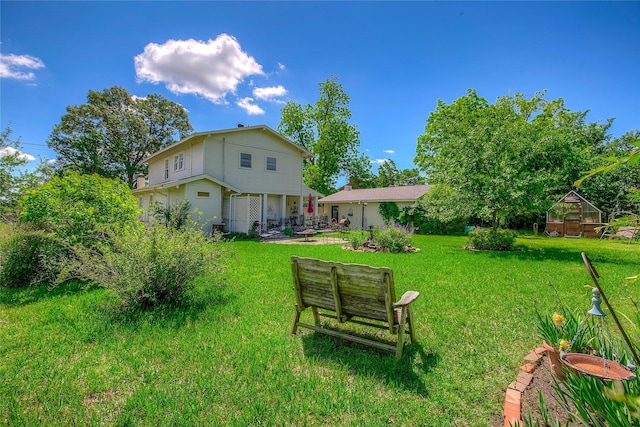 1005 Church St, Sulphur Springs, TX 75482 - view of green lawn featuring a greenhouse and an outdoor structure