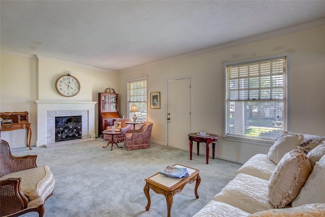 1005 Church St, Sulphur Springs, TX 75482 - carpeted living area featuring plenty of natural light, ornamental molding, a textured ceiling, and a fireplace