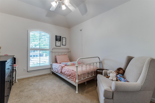 carpeted bedroom with a ceiling fan and lofted ceiling