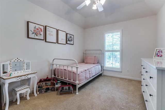 carpeted bedroom featuring a ceiling fan, baseboards, and vaulted ceiling
