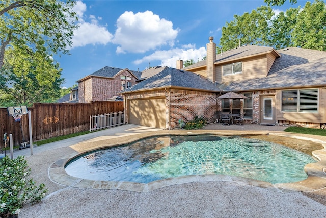 view of swimming pool with a fenced backyard and a patio